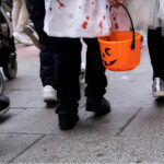Children in customes walking on the street in halloween