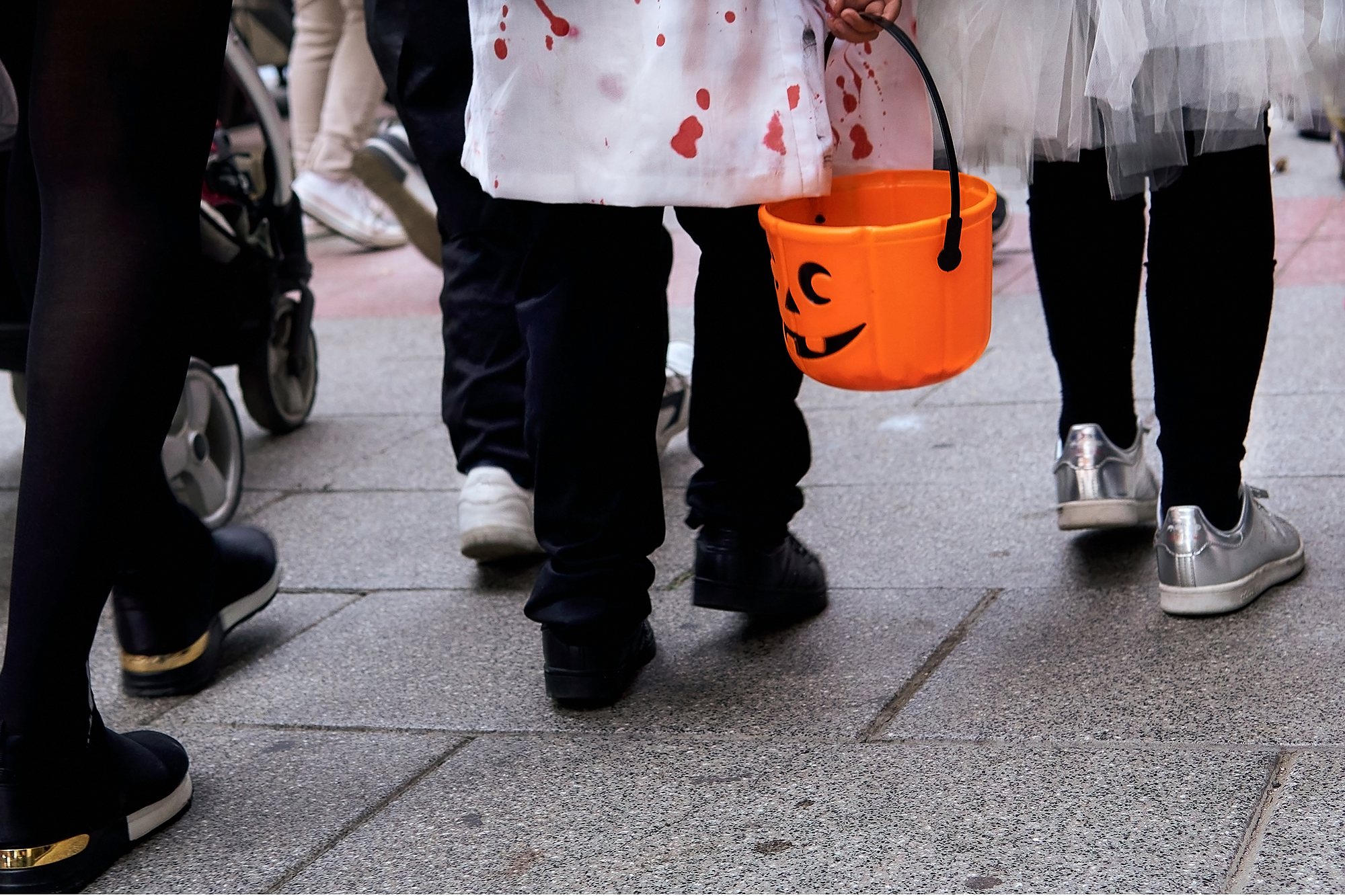 Children in customes walking on the street in halloween